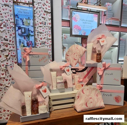 A display of Fresh skincare products and gift sets, beautifully packaged with pink ribbons and floral motifs.