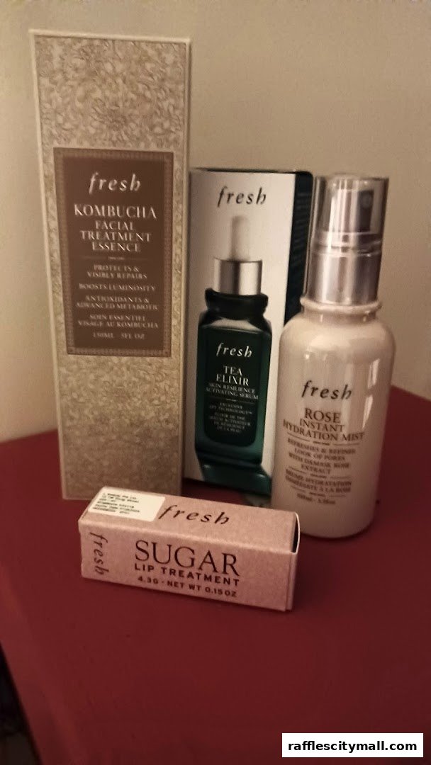 A collection of Fresh skincare products including Kombucha essence, Tea Elixir, Rose mist, and Sugar lip treatment.