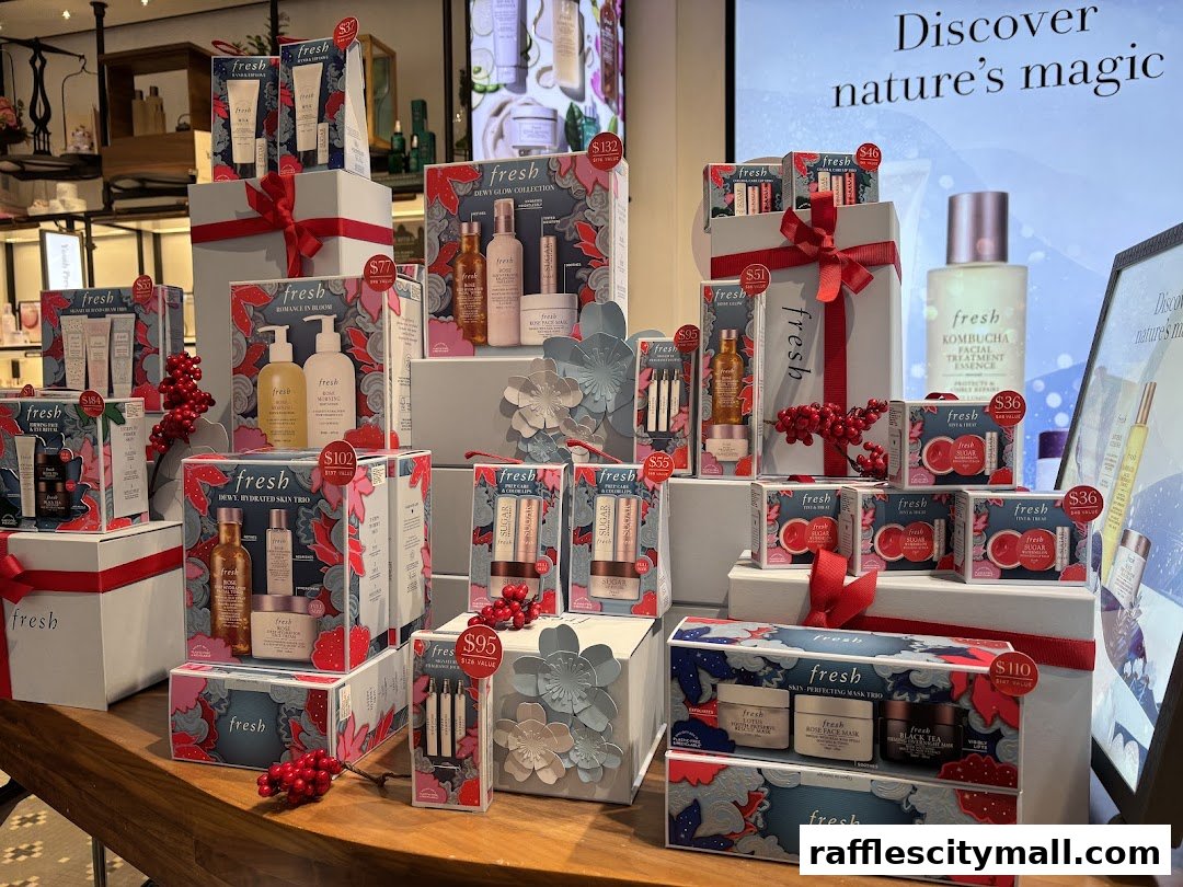 A display of Fresh skincare gift sets and products, featuring holiday-themed packaging.