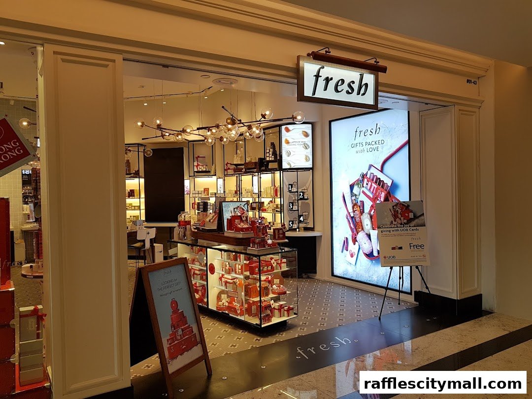 The entrance of a Fresh beauty store, showcasing products and a promotional display.