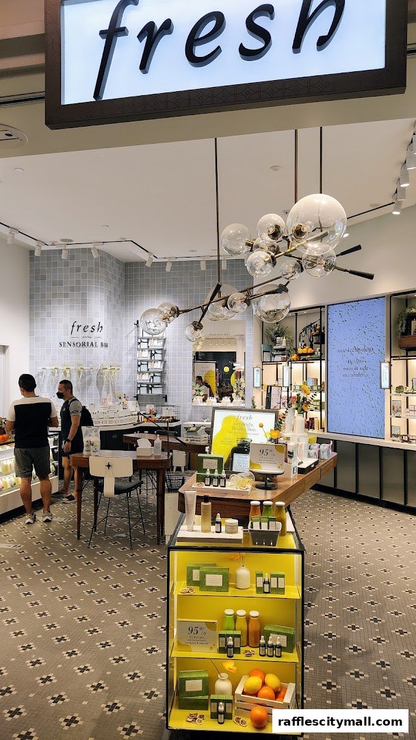 Interior view of a Fresh beauty store with products displayed on shelves and a central island.