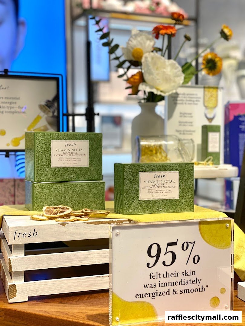 Fresh Vitamin Nectar Glow Juice Antioxidant Face Serum displayed with marketing signage.
