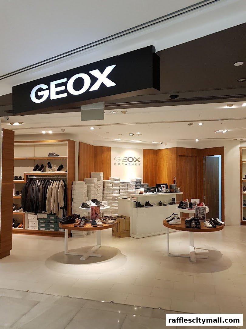 The Geox store entrance displays shoes and apparel on shelves and tables.