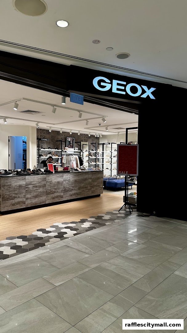 The entrance of a Geox shoe store with a display of shoes and a 'SALE' sign.