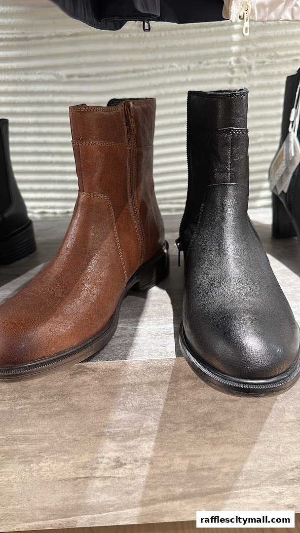 Close-up view of stylish brown and black leather boots on display.