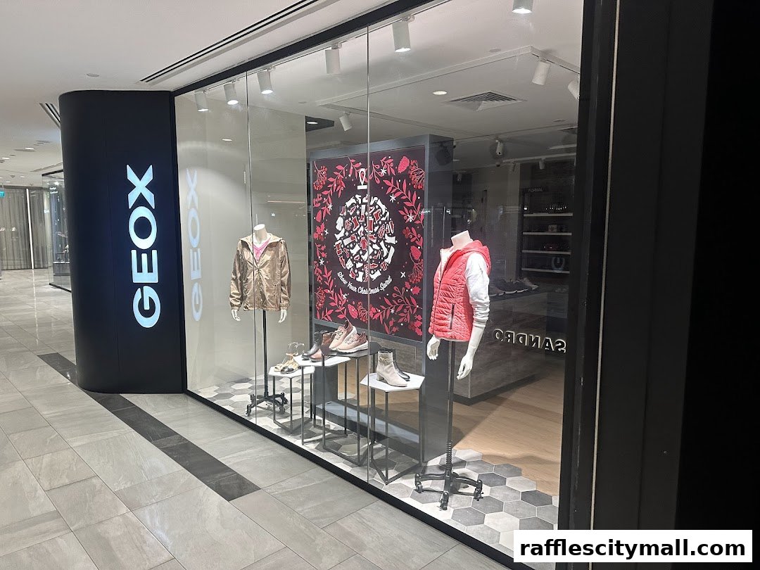 Geox store front with mannequins displaying jackets and shoes in the window.