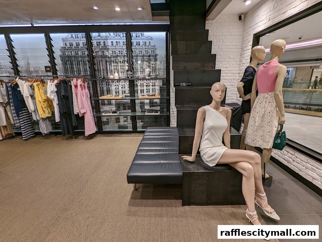 Mannequins display stylish outfits in a modern clothing store with racks of apparel.