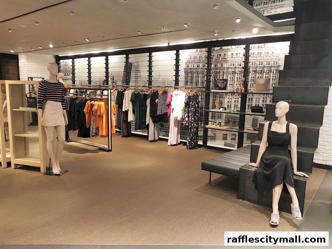 Interior view of a clothing store with mannequins and racks of apparel.