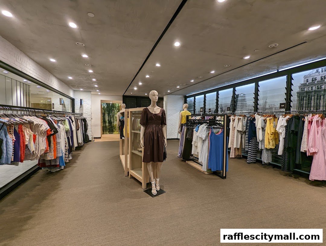 Interior view of a clothing store with racks of apparel and mannequins.