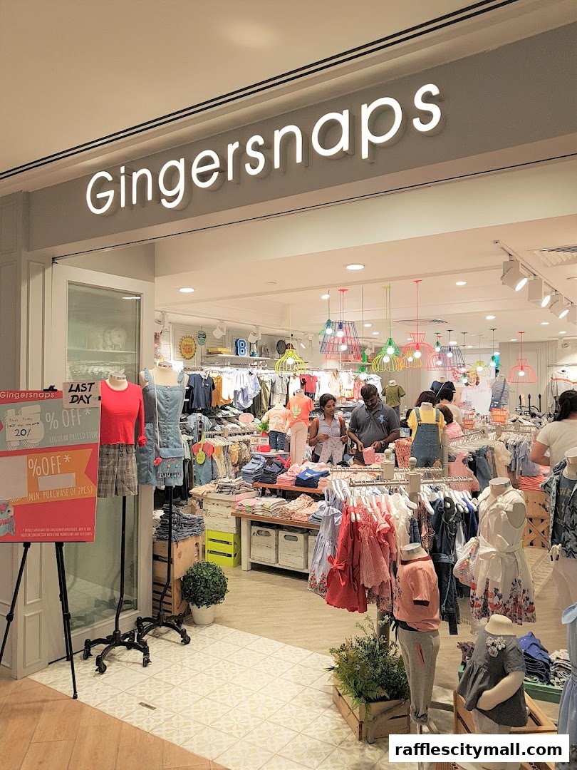 The entrance of a Gingersnaps clothing store, showcasing children's apparel and sale signs.
