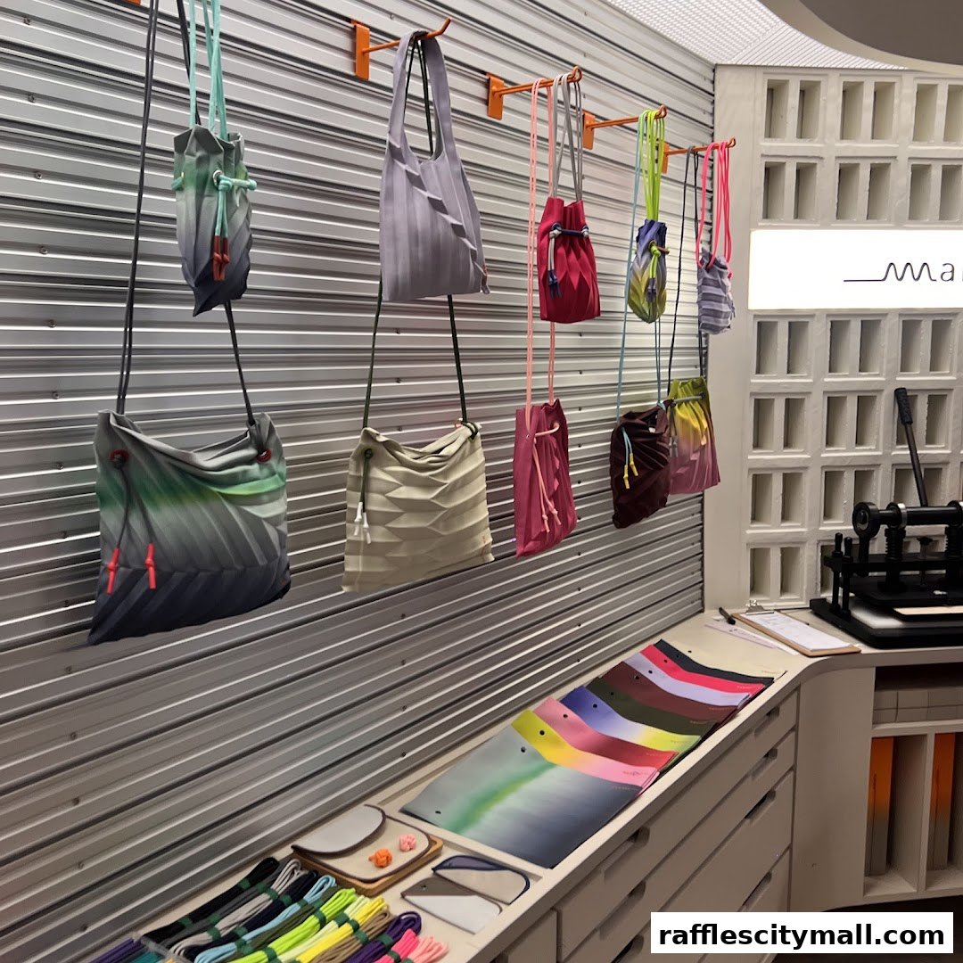A display of colorful pleated bags and accessories in a modern retail store.