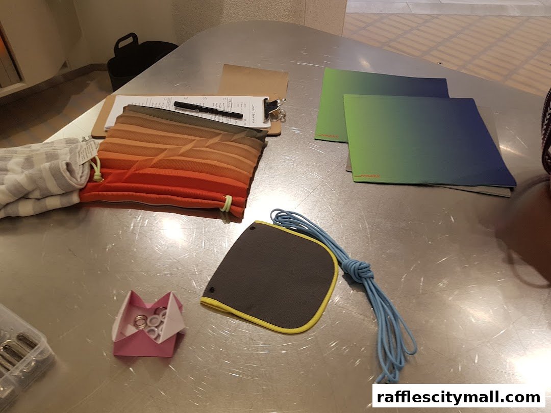 A table displaying various items including fabric pouches, color swatches, and crafting supplies.