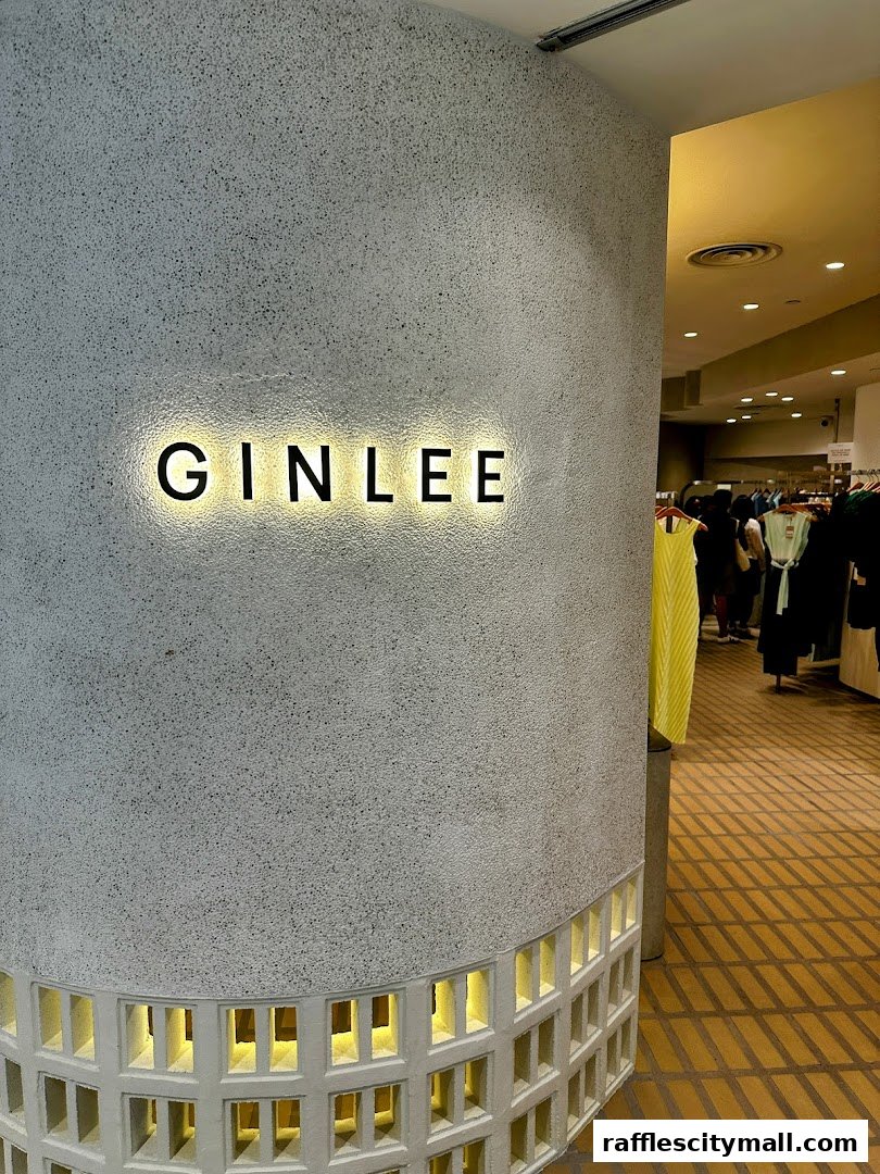 The GINLEE Studio store entrance with illuminated signage and clothing displays visible inside.