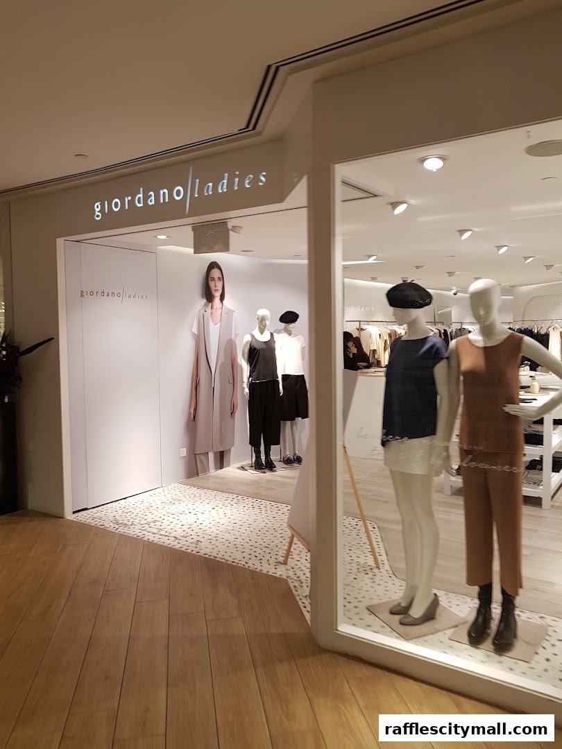 The entrance and display window of Giordano Ladies, showcasing mannequins in stylish outfits.
