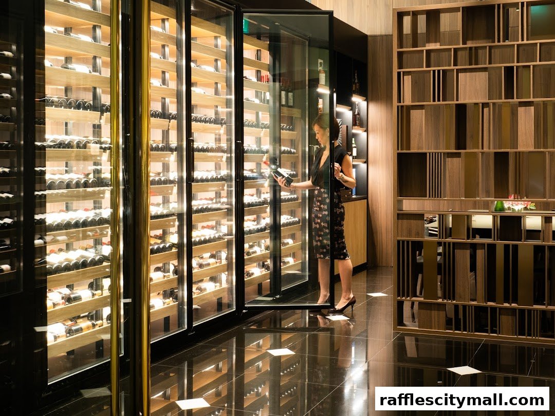A woman selects a bottle of wine from a climate-controlled display at Grand Cru Wine Concierge.