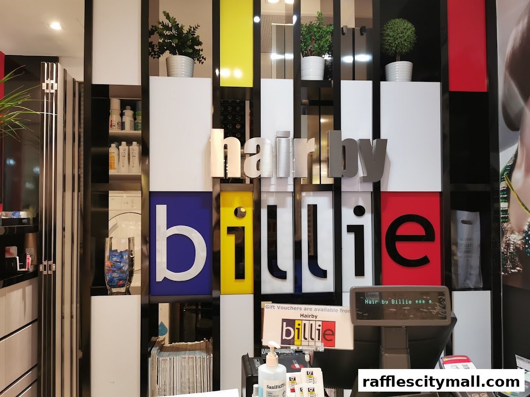 The interior of a modern hair salon with the "Hair by Billie" logo prominently displayed.