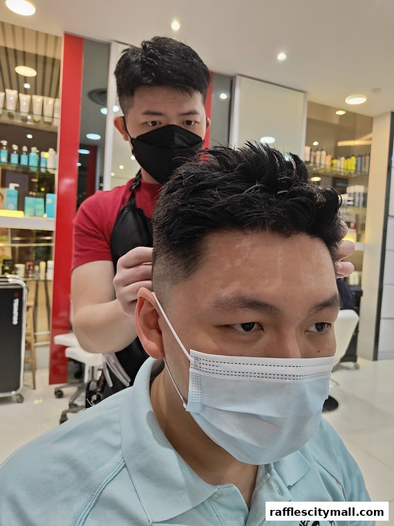 A hairstylist gives a client a haircut in a modern salon.