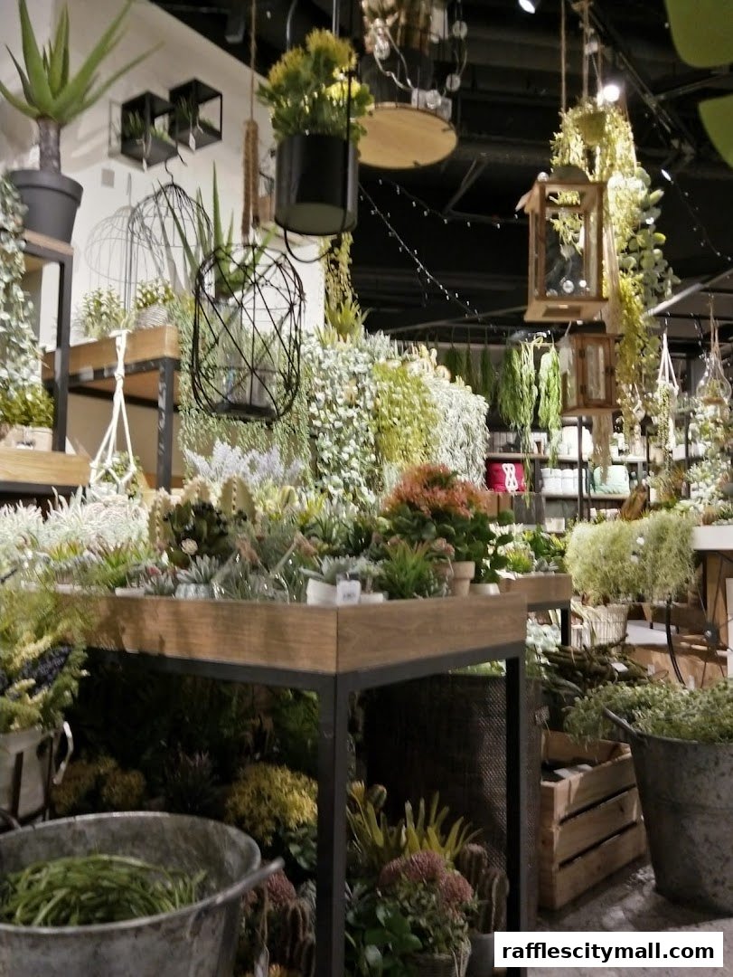 A shop interior filled with various artificial plants, succulents, and decorative items.