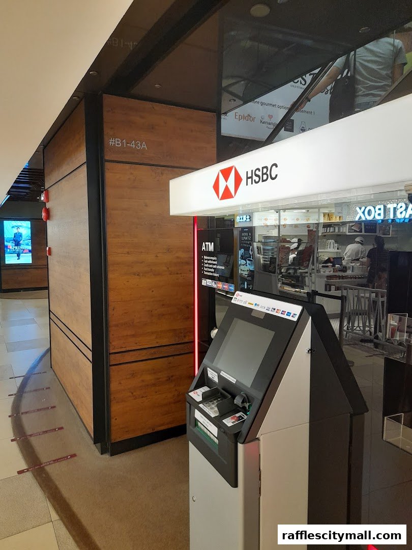 HSBC bank branch with an ATM and a wooden-paneled wall.