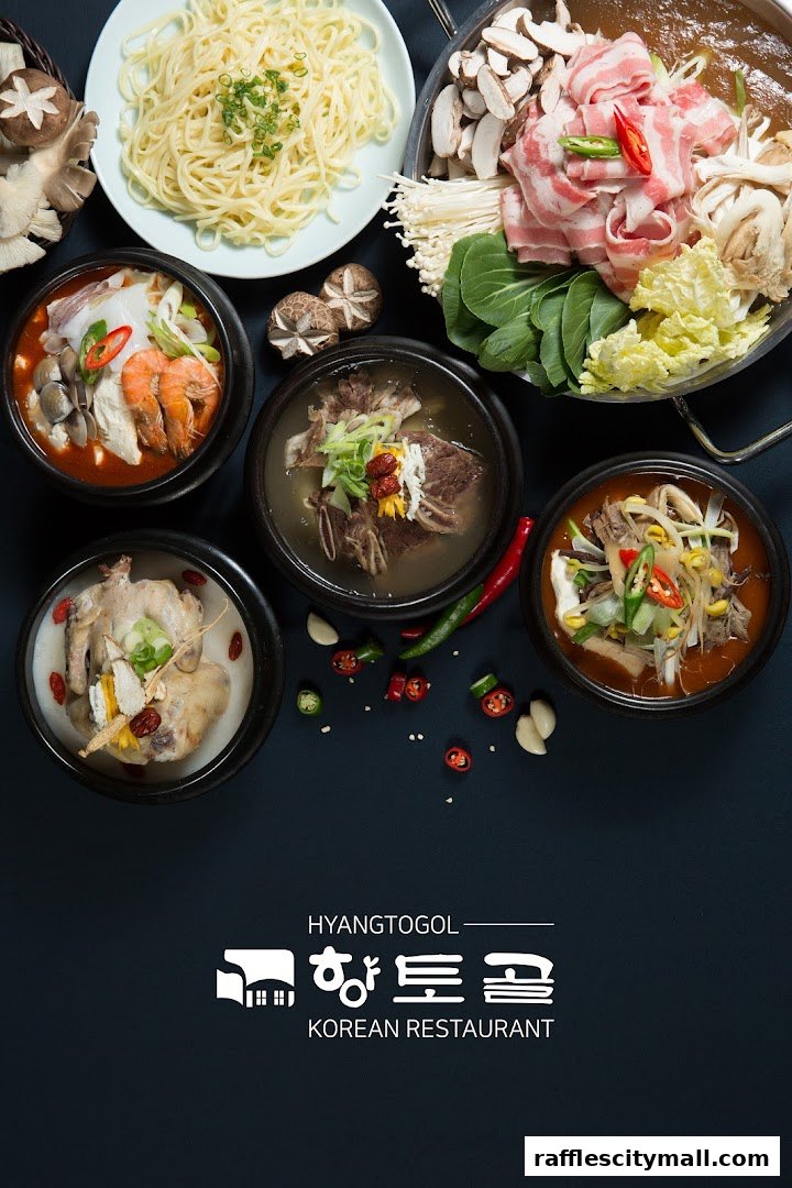 A spread of delicious Korean dishes including hot pots, noodles, and whole chicken soup.