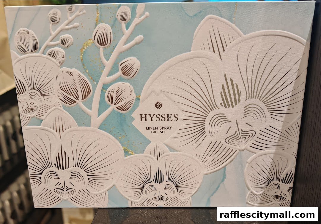 A gift set box for HYSSES Linen Spray with an elegant orchid design.