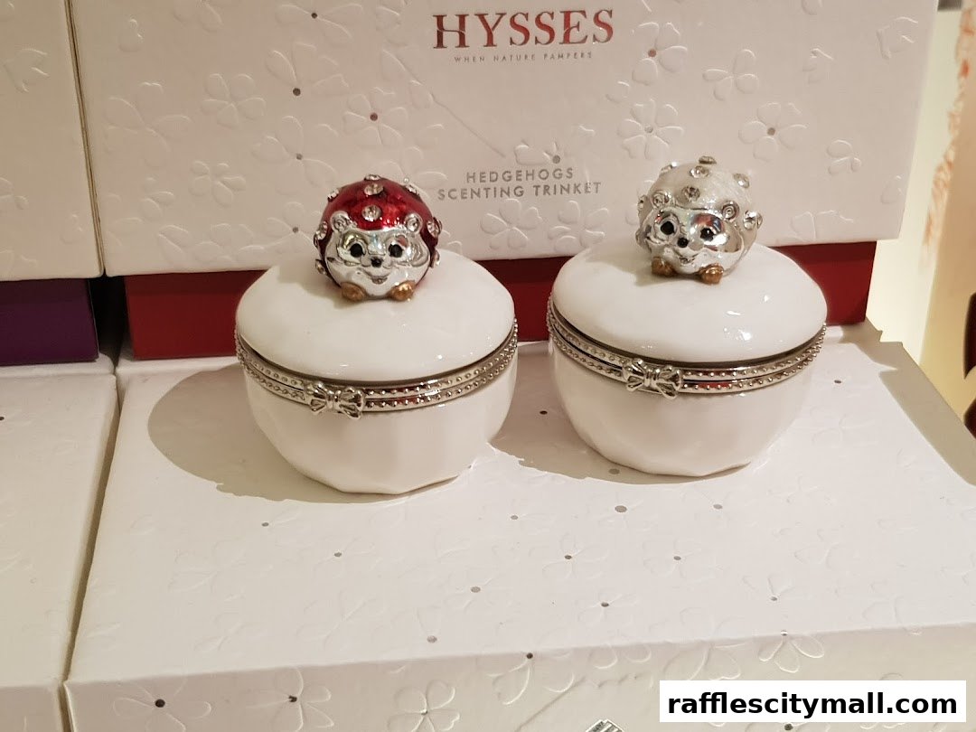 Two decorative hedgehog trinket boxes with sparkling details on display.