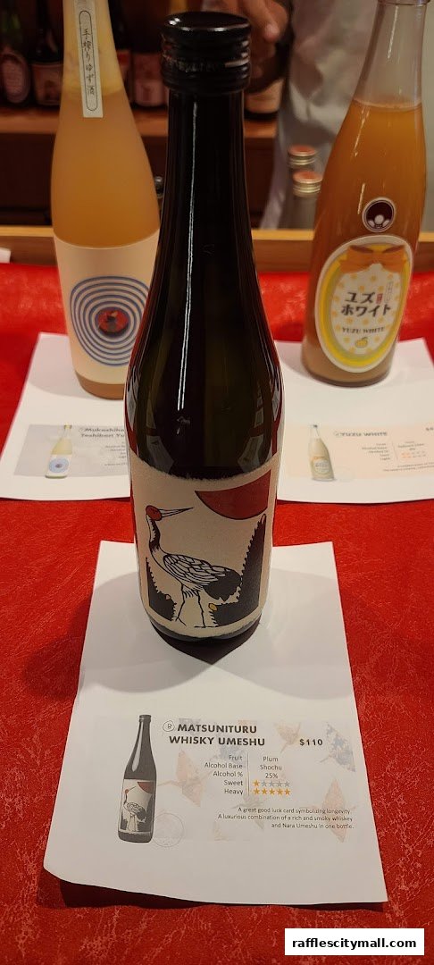 Bottles of Japanese sake and umeshu displayed on a red tablecloth.