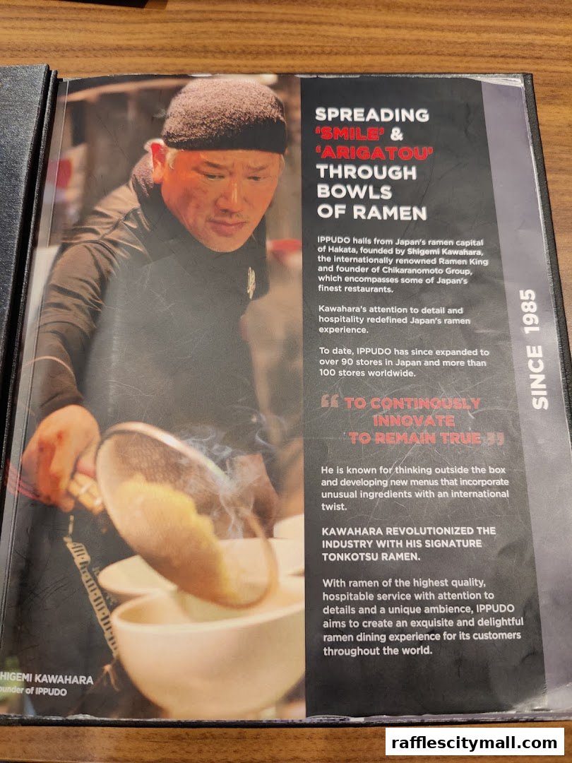 A page from a menu featuring the founder of IPPUDO, Shigemi Kawahara, preparing ramen.