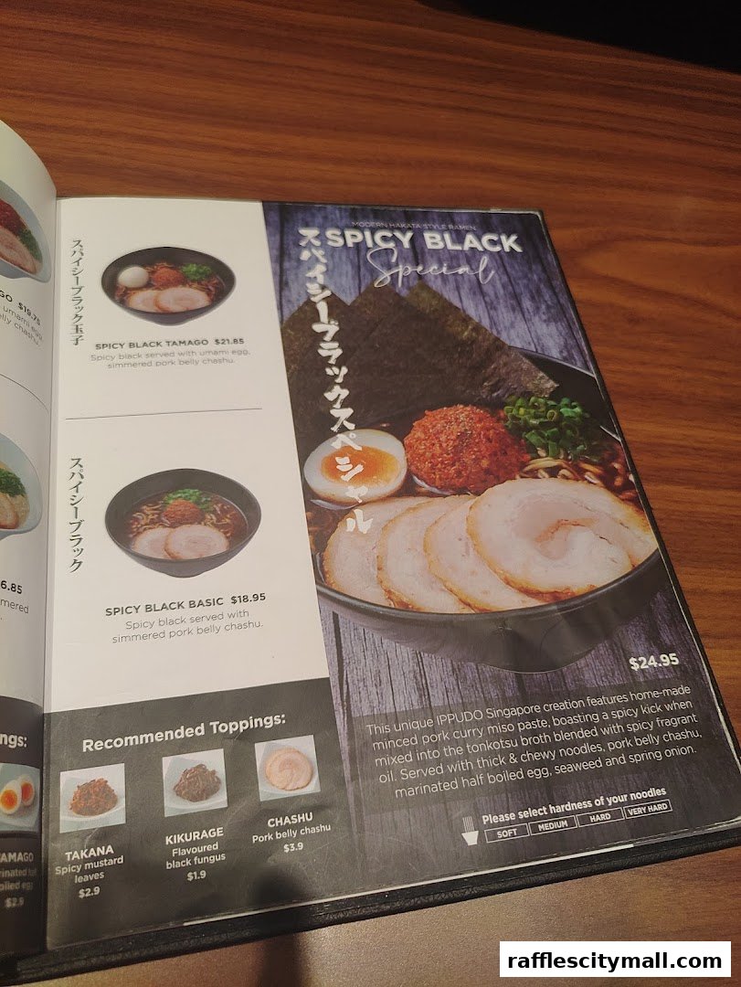 A menu page showcasing IPPUDO's Spicy Black ramen and recommended toppings.