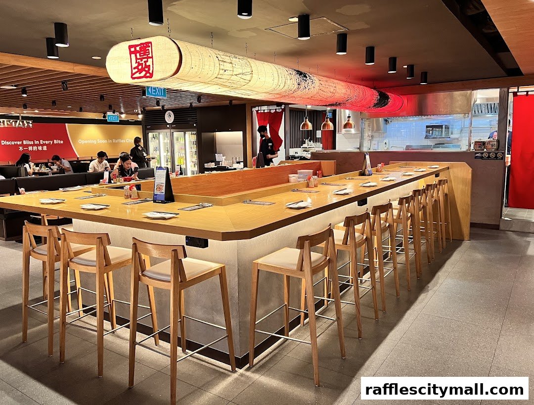 Interior of a modern Japanese restaurant with a long counter and bar stools.