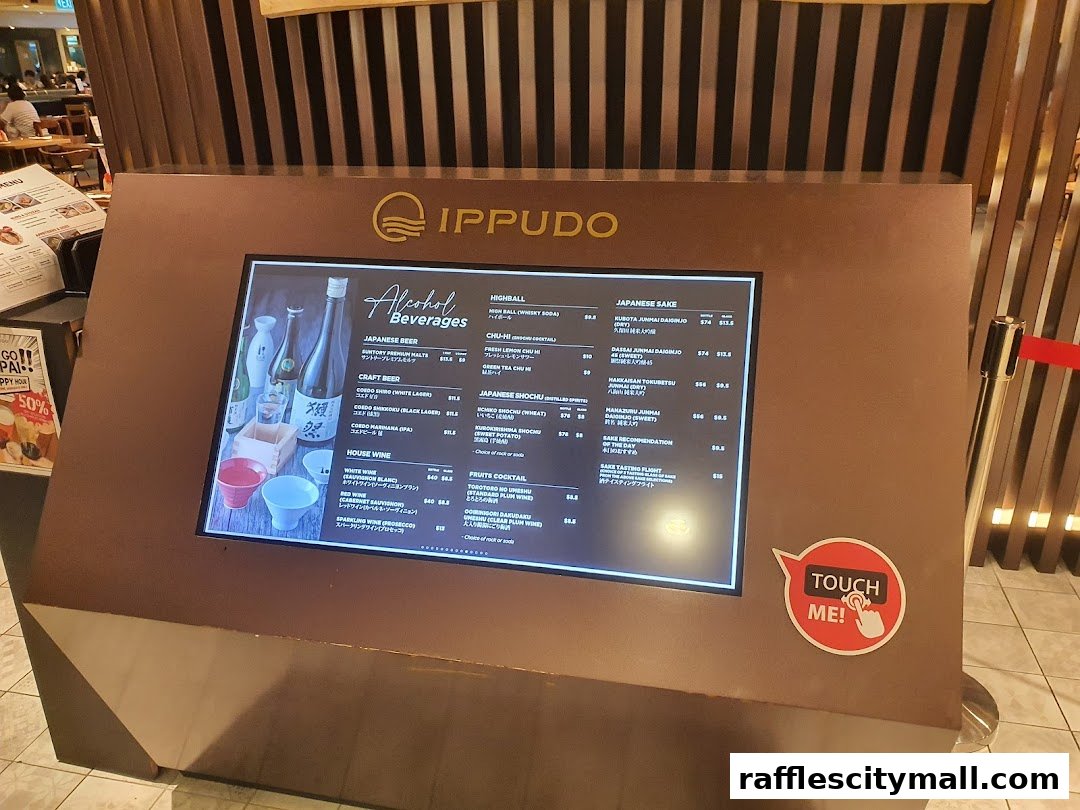 A digital menu board displaying alcoholic beverages at IPPUDO Raffles City.