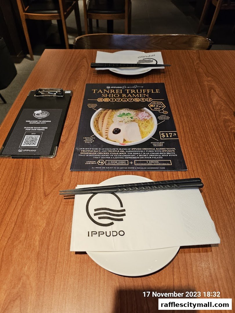 A table setting at IPPUDO Raffles City featuring a menu for Tanrei Truffle Shio Ramen.