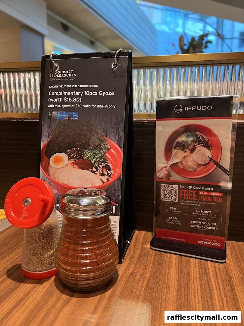 A table at IPPUDO Raffles City with a ramen menu and condiments.