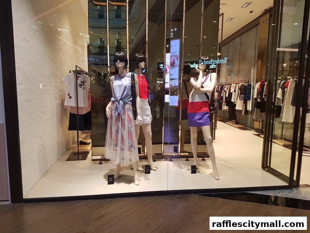 Mannequins display stylish outfits in a well-lit fashion boutique window.