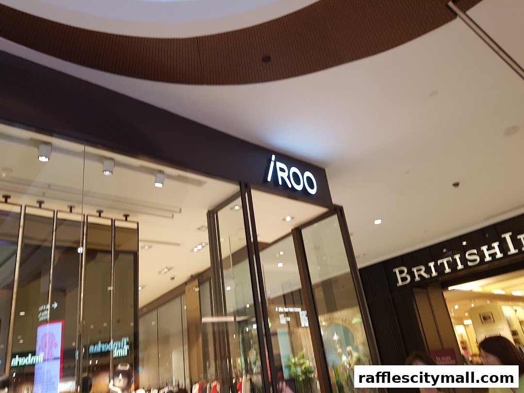 The illuminated 'iROO' sign above a modern shop entrance with glass panels.