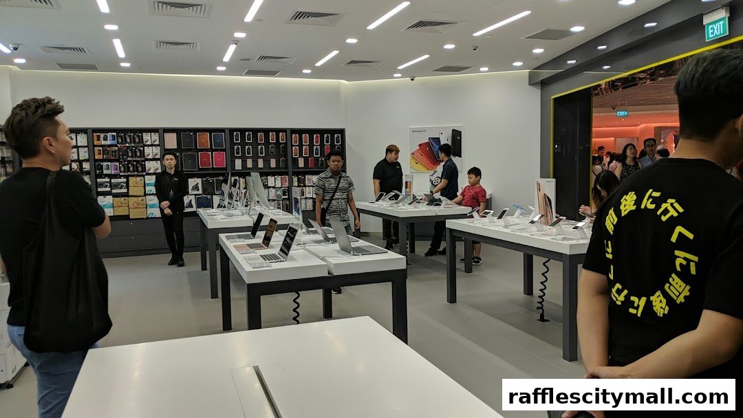 Interior view of an iStudio store showcasing Apple products and accessories with customers browsing.