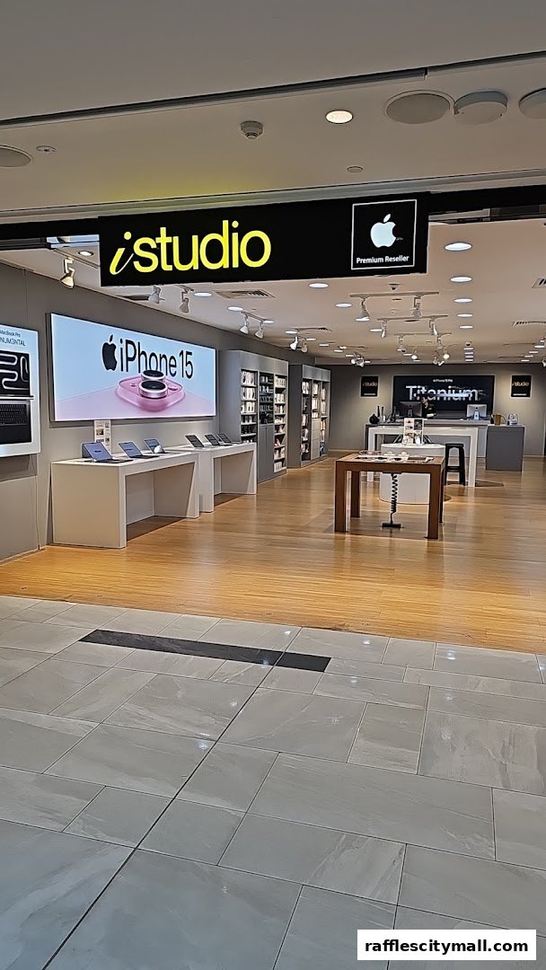 The interior of an iStudio Apple Premium Reseller store showcasing iPhone 15 and other Apple products.