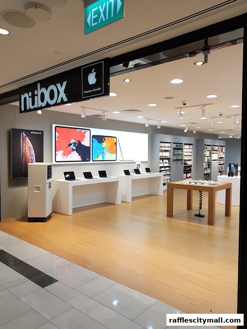 The interior of an Apple Premium Reseller shop, showcasing display tables with laptops and iPads.