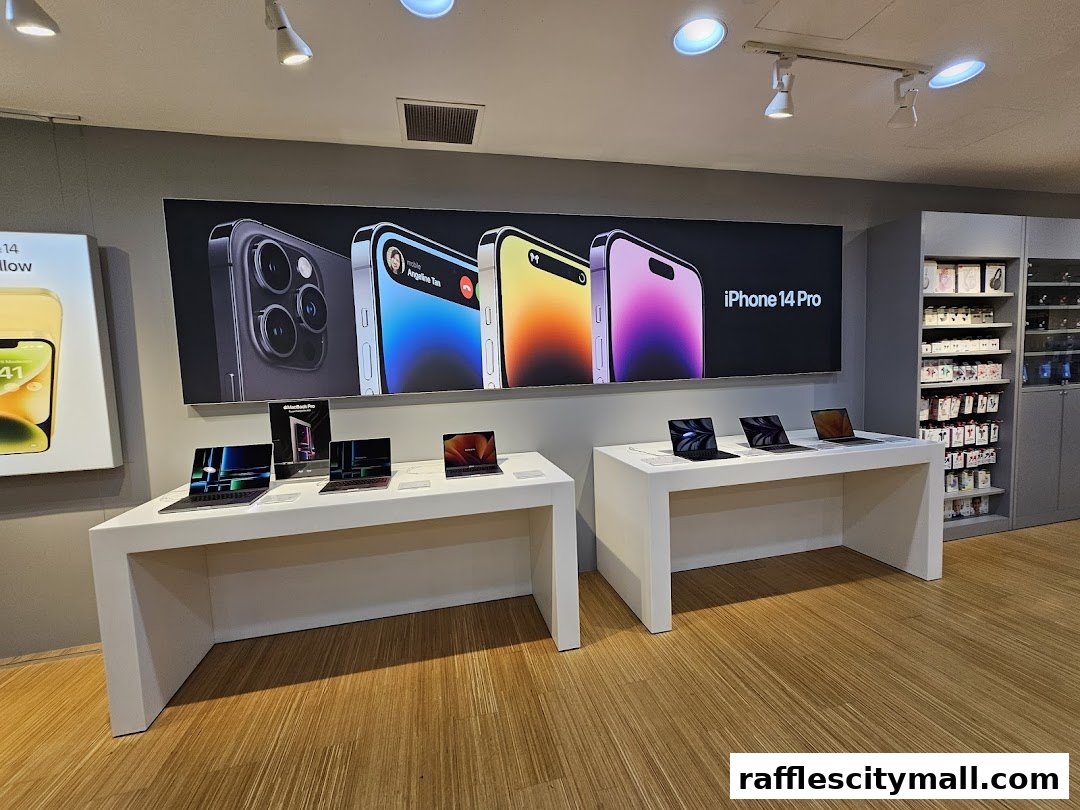 Interior view of an iStudio store showcasing iPhones and MacBooks on display.