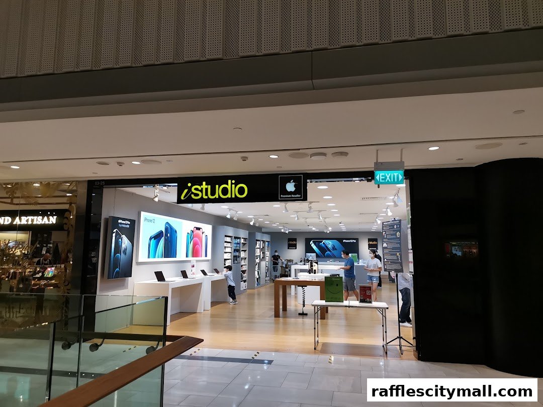 The iStudio Apple Premium Reseller store entrance with displays of iPhones and laptops.