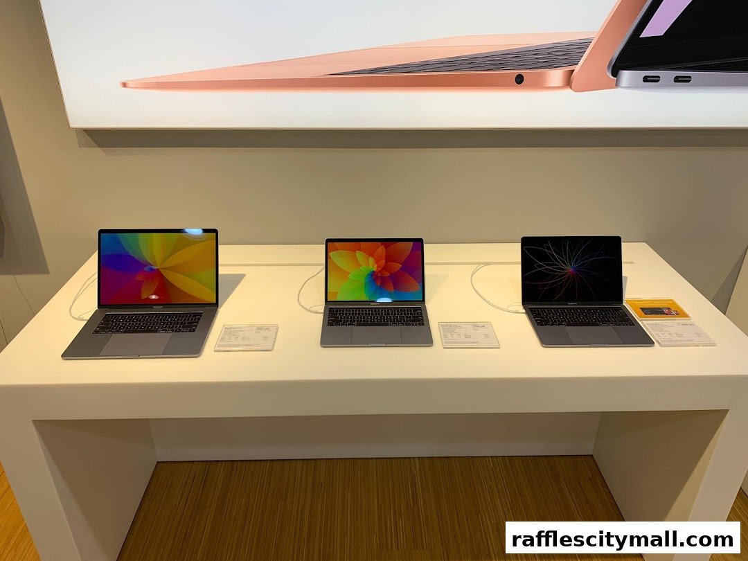Three MacBooks are displayed on a white counter with colorful screens.