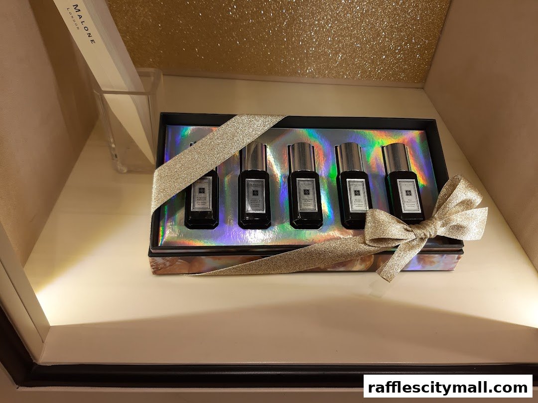 A gift set of Jo Malone London colognes displayed with a glittery ribbon.