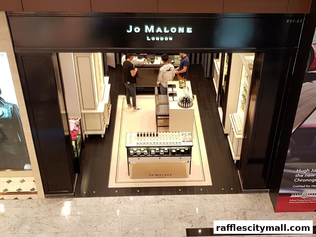 The entrance of a Jo Malone London store with customers inside browsing products.