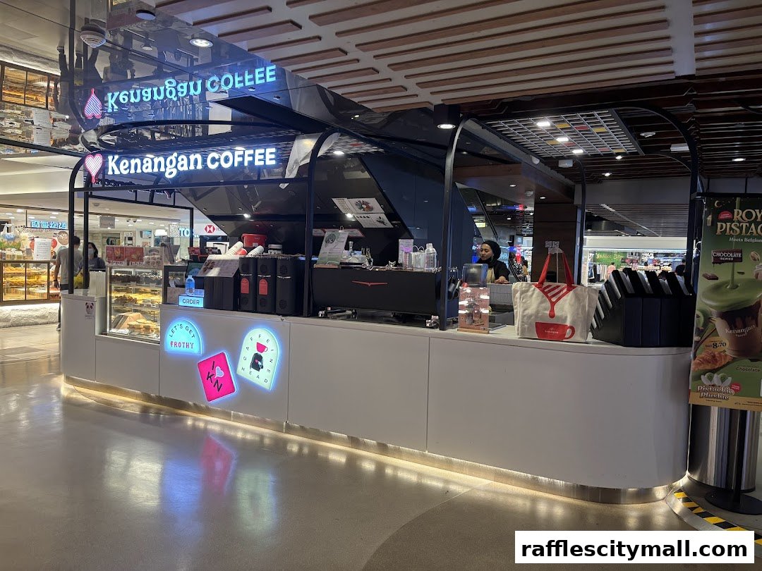 A Kenangan Coffee shop counter with a barista and various coffee-making equipment.