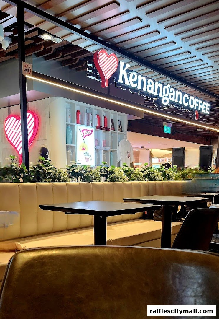Interior view of Kenangan Coffee with seating, tables, and the shop's logo.
