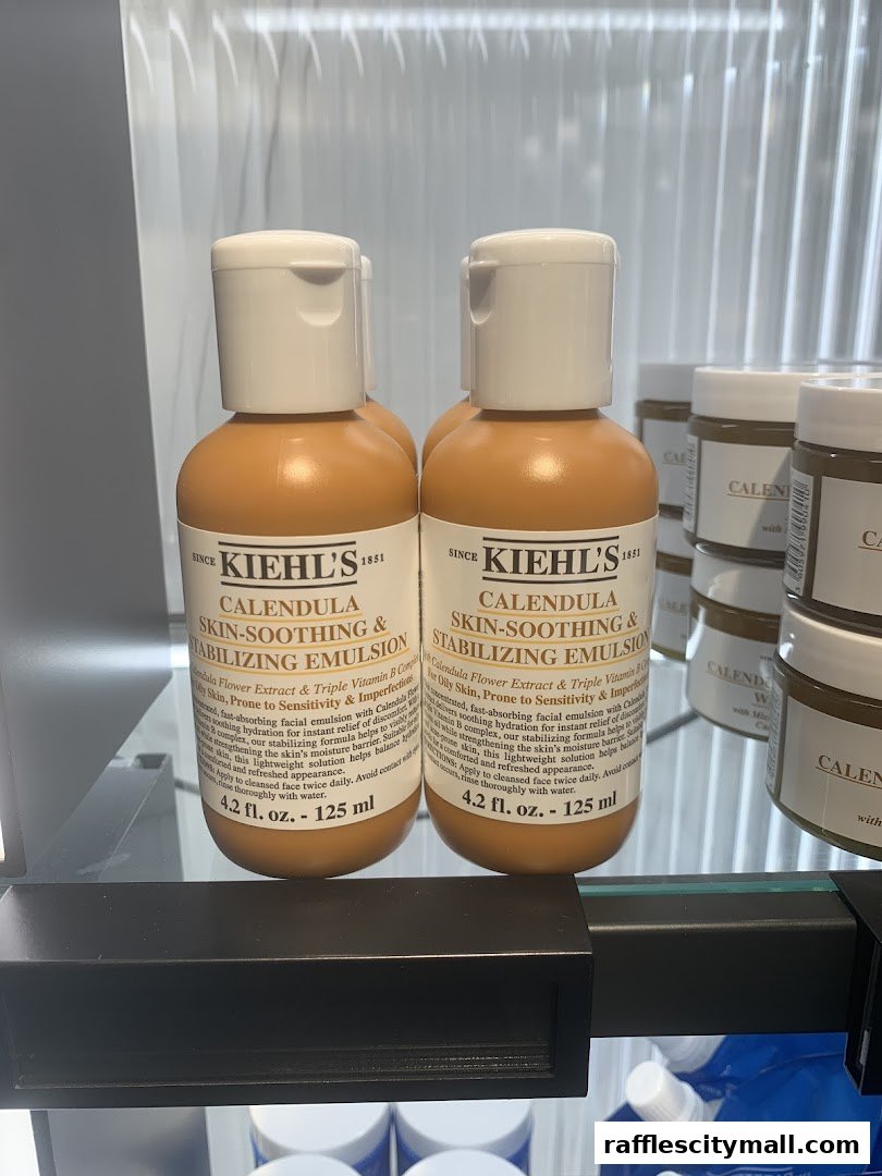 Two bottles of Kiehl's Calendula Skin-Soothing & Stabilizing Emulsion displayed on a shelf.