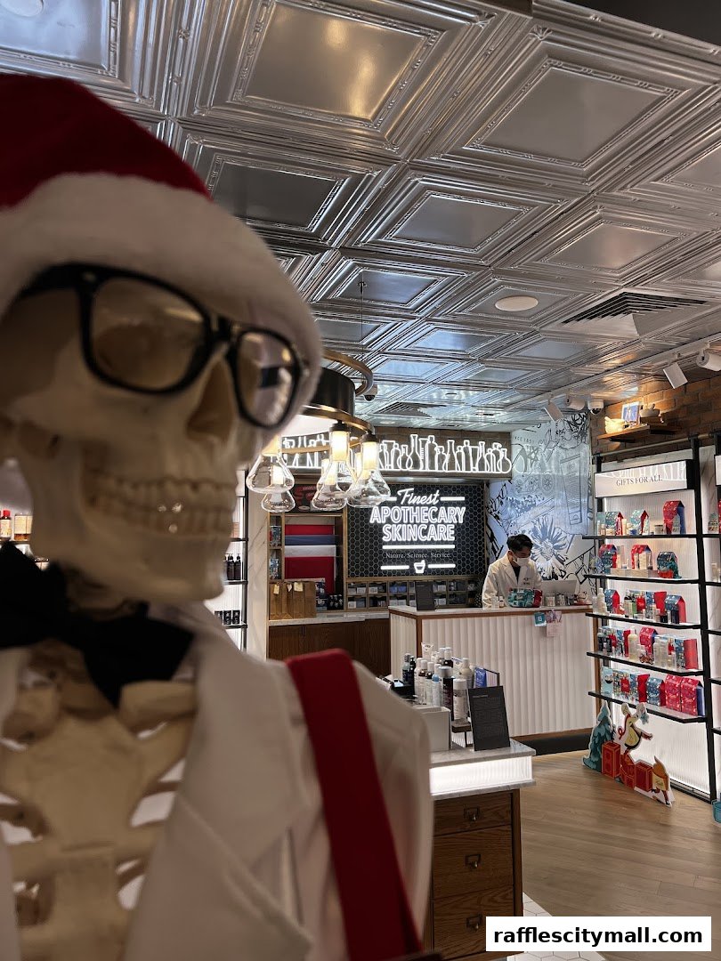 A skeleton wearing a Santa hat and glasses stands in front of a Kiehl's skincare store.