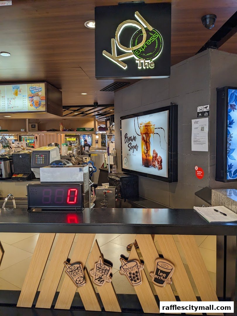The counter of KOI Thé Express with a prominent sign and a digital display.
