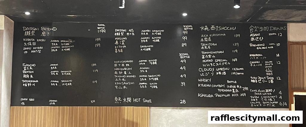 A black chalkboard menu displaying various Japanese sake, shochu, and other drinks with prices.