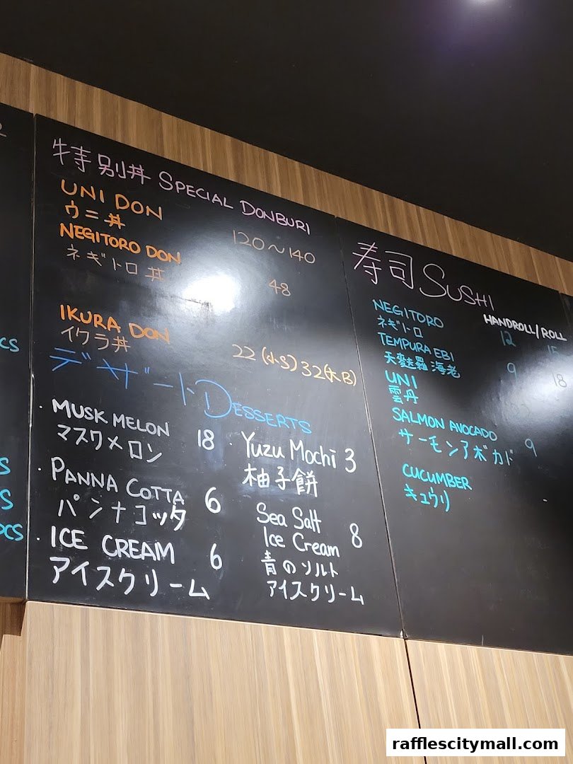 A menu board at Koji Sushi Bar displays various sushi, donburi, and dessert items with prices.